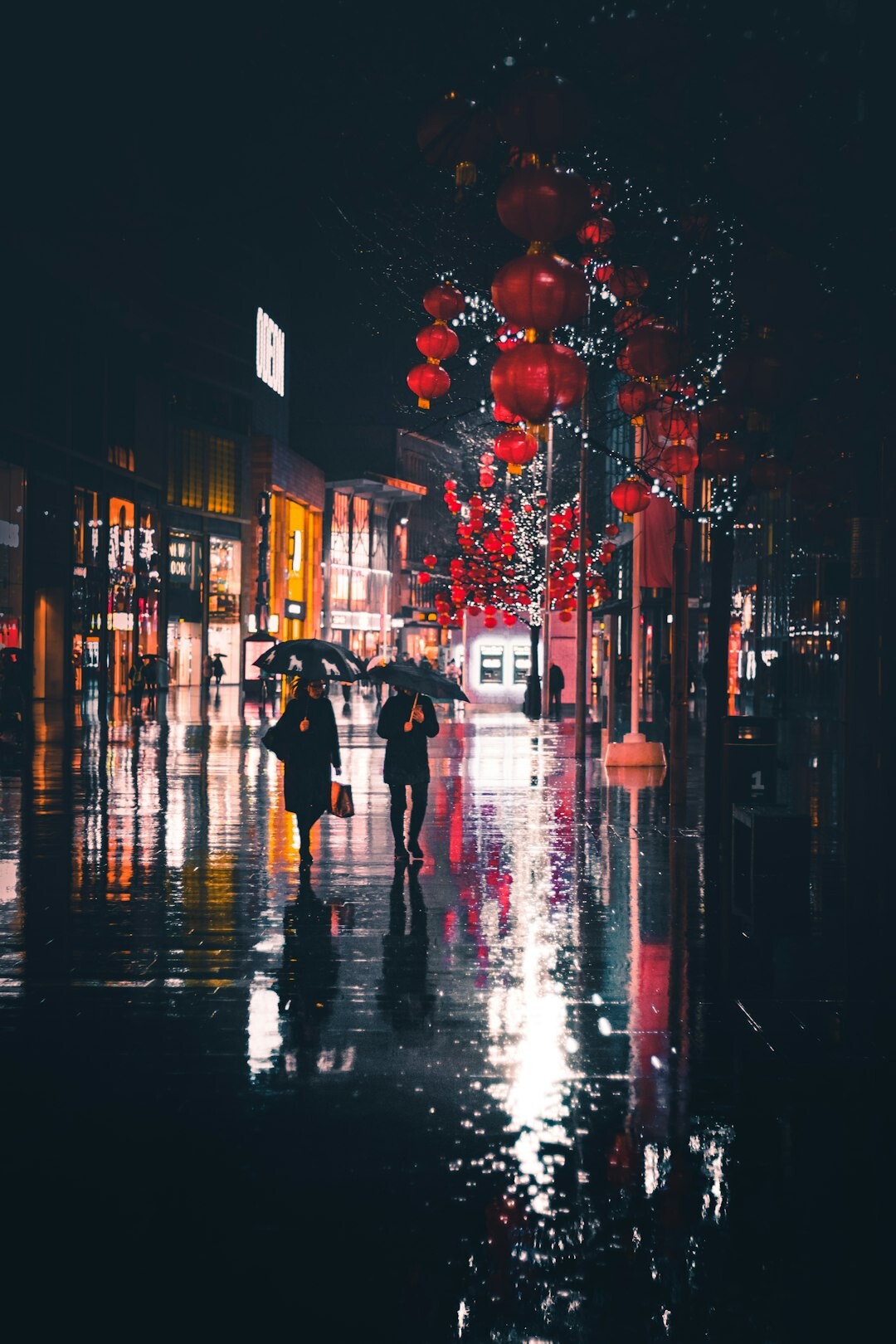 Rainy Zagreb street at night with an old lantern reflecting on wet cobblestones